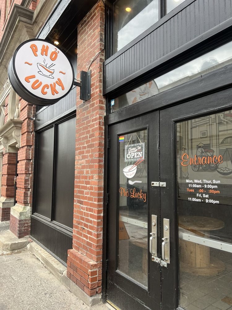 Pho Lucky storefront with its orange sign and entrance